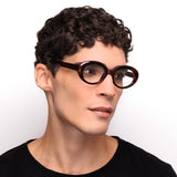 Óculos Oval I10 Tartaruga em modelo com rosto grande.